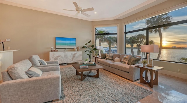 living room featuring tile patterned flooring, ceiling fan, and crown molding