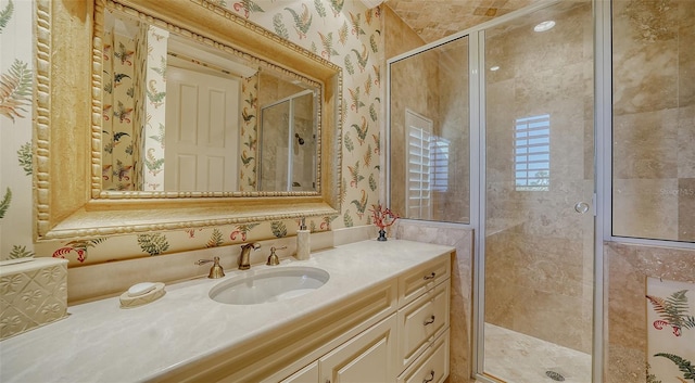 bathroom with vanity and a shower with door