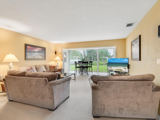 living room with light carpet and a textured ceiling