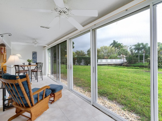 sunroom featuring ceiling fan