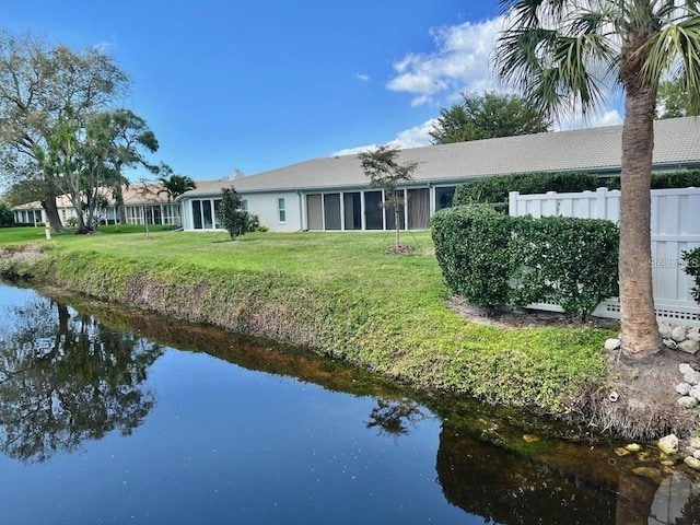 back of house with a lawn