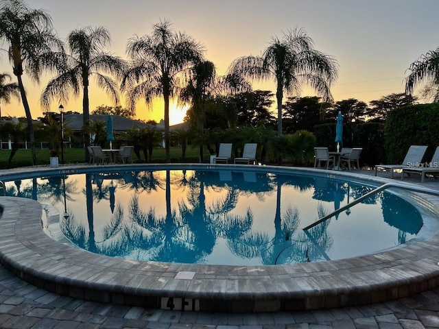 view of pool at dusk