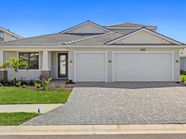 view of front of house with a garage and a front yard