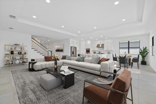 living room with a tray ceiling