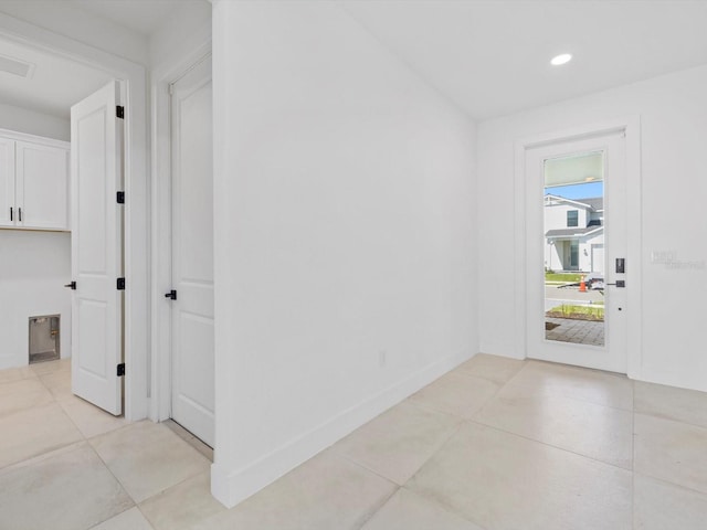 entryway with light tile patterned floors