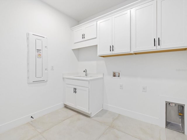 laundry area with washer hookup, electric panel, light tile patterned flooring, sink, and cabinets