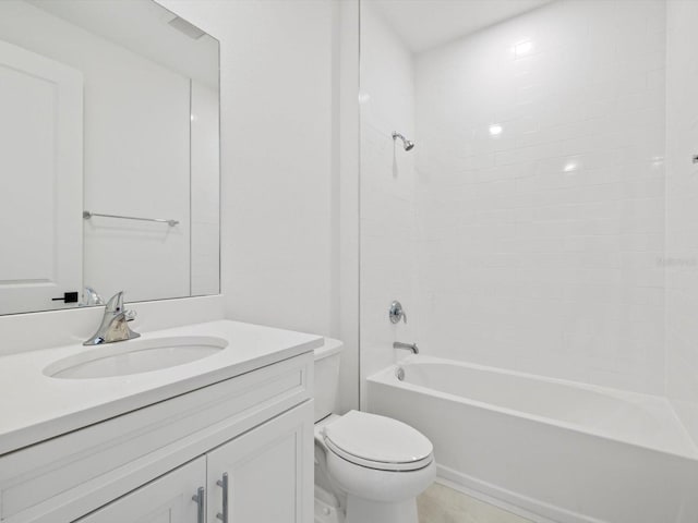 full bathroom featuring tiled shower / bath, vanity, and toilet