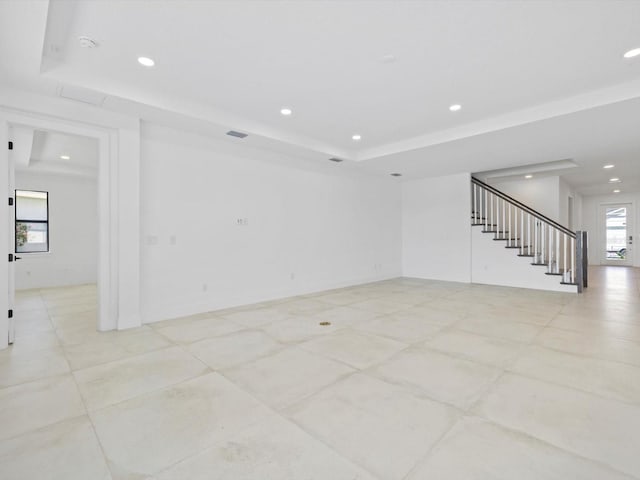 unfurnished room with a tray ceiling