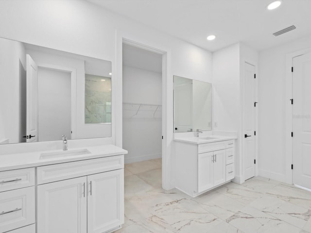 bathroom featuring a shower and vanity