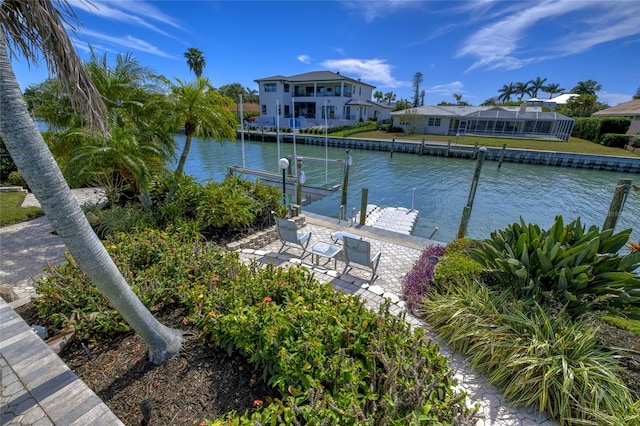 view of dock with a lanai and a water view