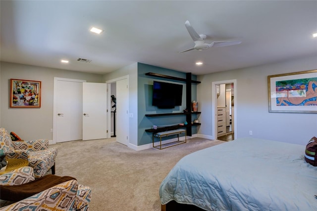 carpeted bedroom featuring ensuite bath and ceiling fan