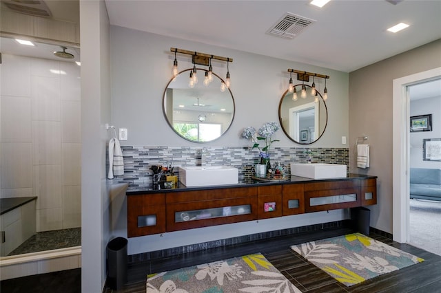 bathroom with tasteful backsplash and double vanity