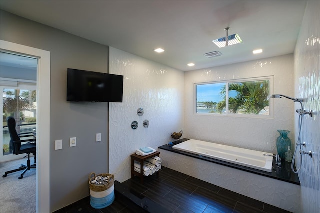 bathroom featuring a bath and tile floors