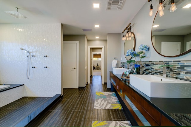 bathroom featuring tile flooring, backsplash, and double vanity