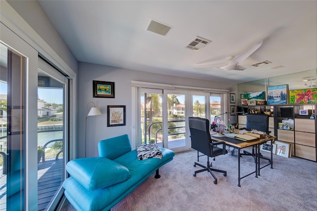 office featuring light colored carpet, ceiling fan, and french doors