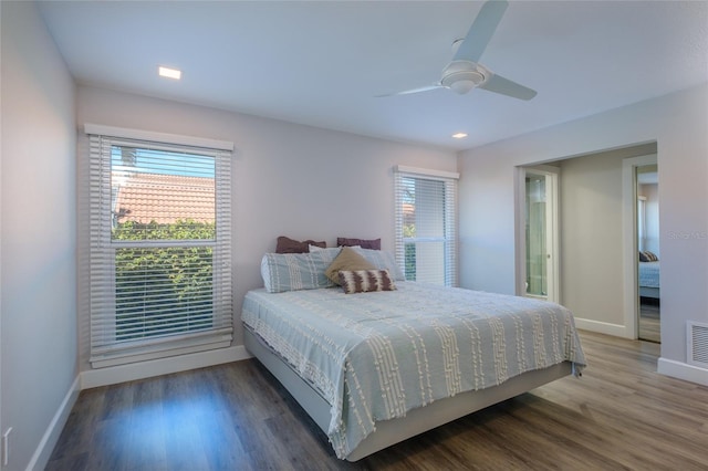 bedroom with ceiling fan and dark hardwood / wood-style flooring