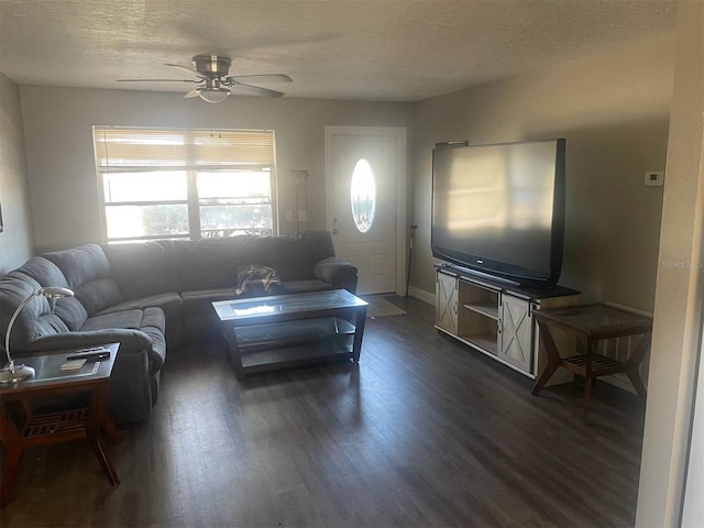 living room featuring dark hardwood / wood-style flooring, a textured ceiling, and ceiling fan