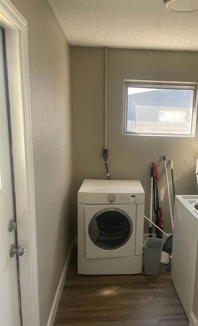 laundry area with electric dryer hookup and dark hardwood / wood-style floors