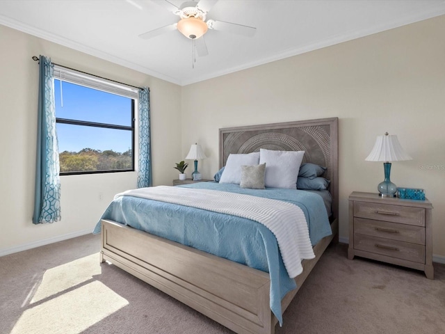 carpeted bedroom featuring crown molding and ceiling fan