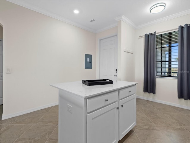 kitchen featuring light stone counters, crown molding, a kitchen island, light tile flooring, and white cabinetry