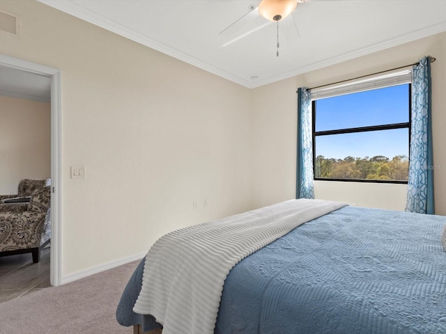 carpeted bedroom with ceiling fan and crown molding