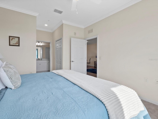 bedroom with ornamental molding, ceiling fan, ensuite bathroom, and carpet