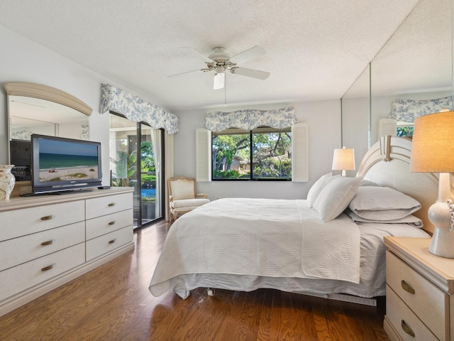 bedroom featuring access to outside, a textured ceiling, ceiling fan, and dark hardwood / wood-style flooring