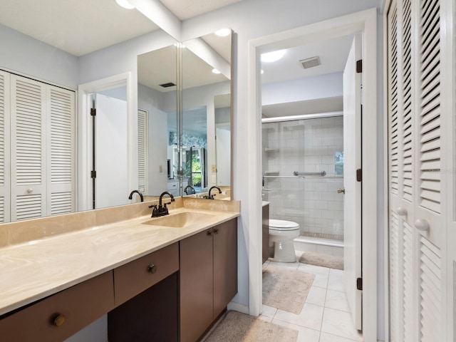 bathroom with vanity, tile floors, and toilet