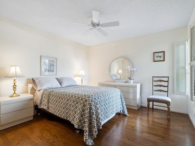 bedroom featuring dark hardwood / wood-style flooring, a textured ceiling, and ceiling fan