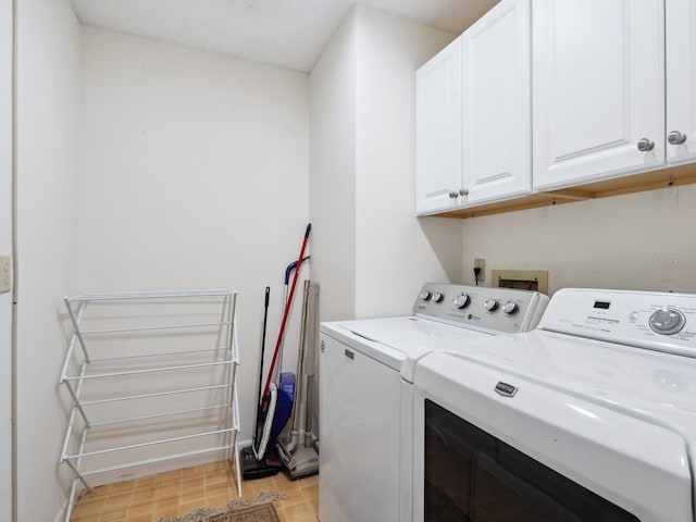 laundry room featuring hookup for a washing machine, washing machine and dryer, cabinets, and light tile floors