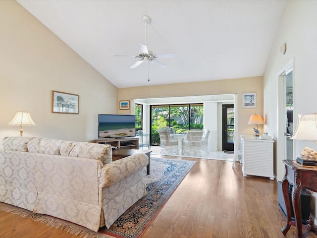 living room featuring high vaulted ceiling, ceiling fan, and light wood-type flooring