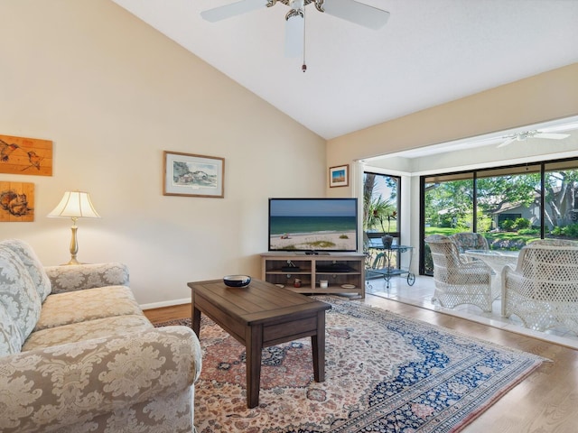 living room featuring light hardwood / wood-style flooring, ceiling fan, and high vaulted ceiling