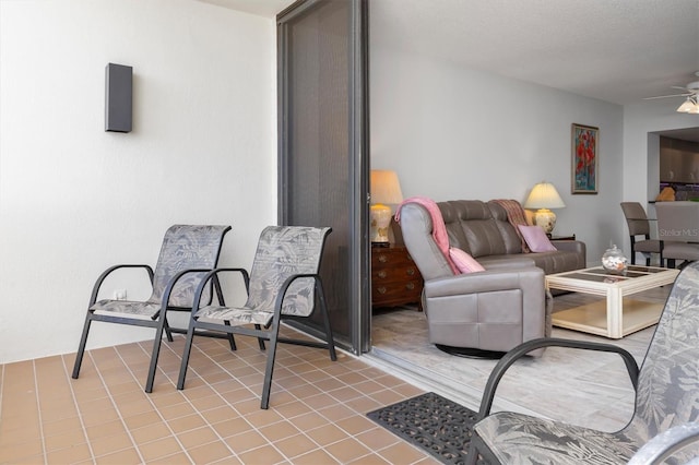 tiled living room featuring a textured ceiling and ceiling fan