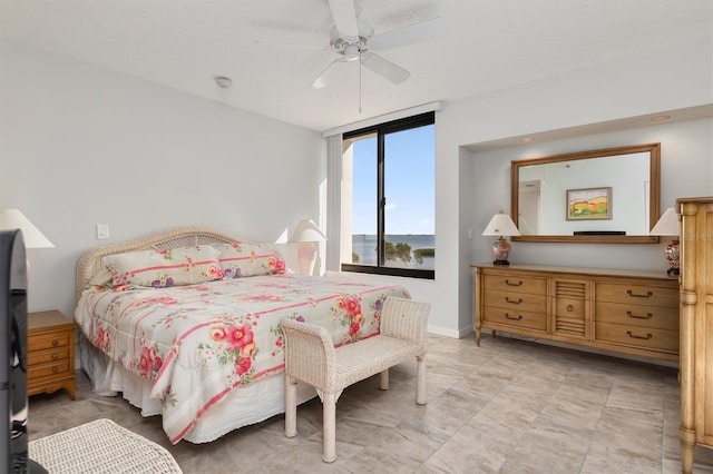 bedroom with ceiling fan and light tile floors