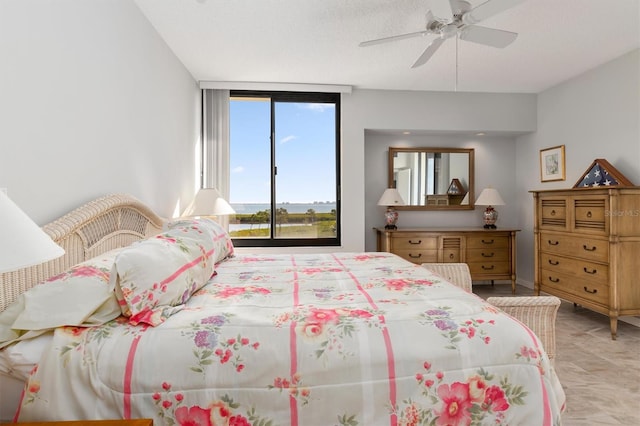 tiled bedroom with ceiling fan and a textured ceiling