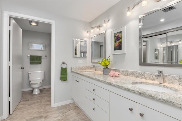 bathroom featuring toilet, dual bowl vanity, and tile flooring