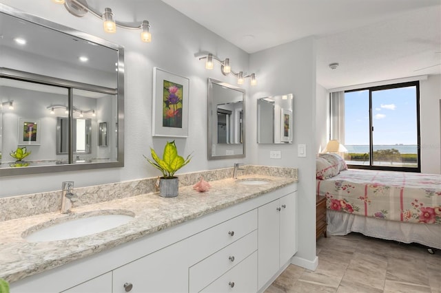 bathroom with vanity with extensive cabinet space, tile flooring, and double sink