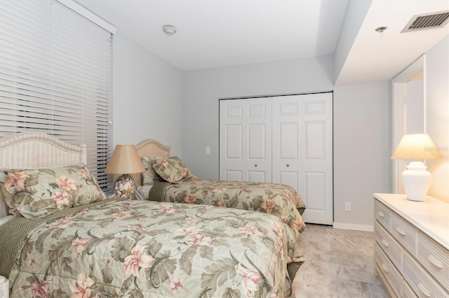 bedroom featuring a closet and light tile floors