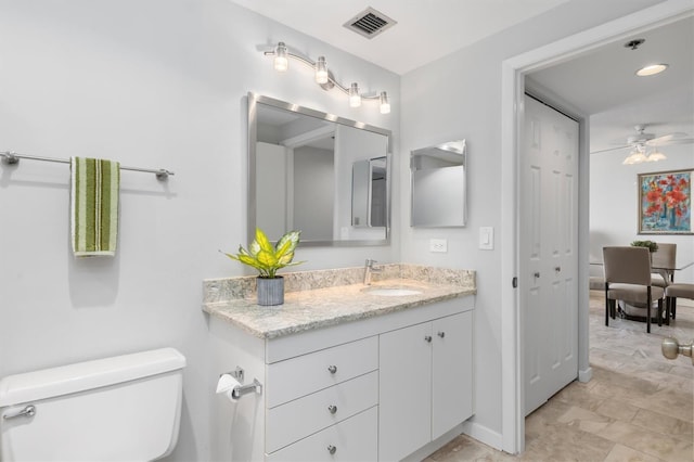 bathroom featuring oversized vanity, toilet, tile floors, and ceiling fan