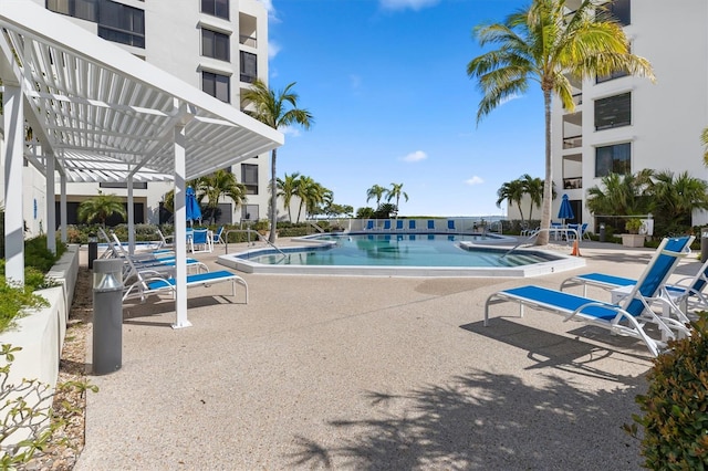 view of pool with a pergola and a patio