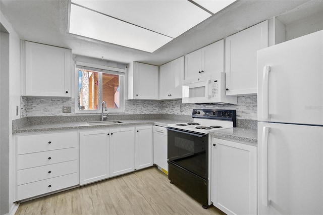 kitchen featuring light wood-type flooring, white appliances, sink, and white cabinets