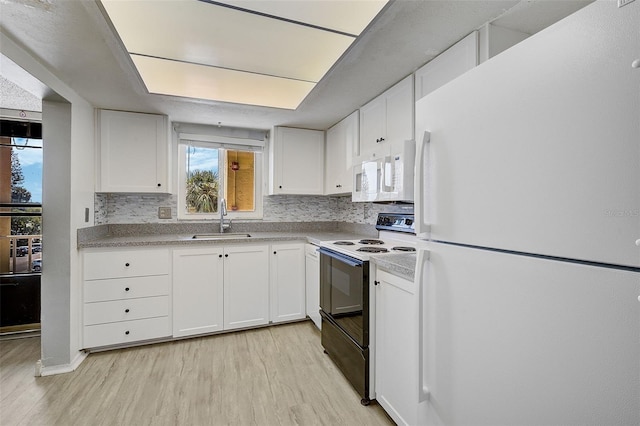 kitchen with sink, white appliances, and white cabinets