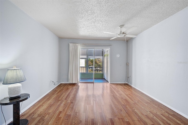 empty room with ceiling fan, a textured ceiling, and light wood-type flooring