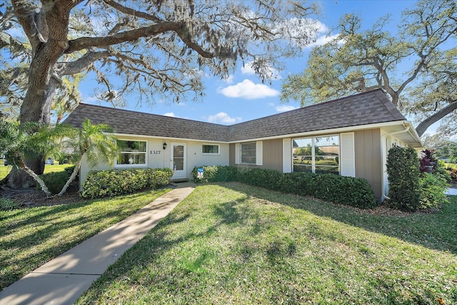 single story home featuring a front yard