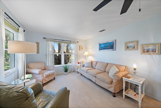 carpeted living room featuring ceiling fan