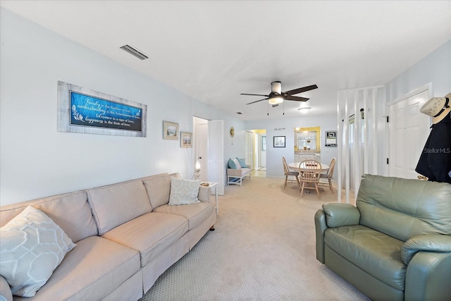 carpeted living room featuring ceiling fan