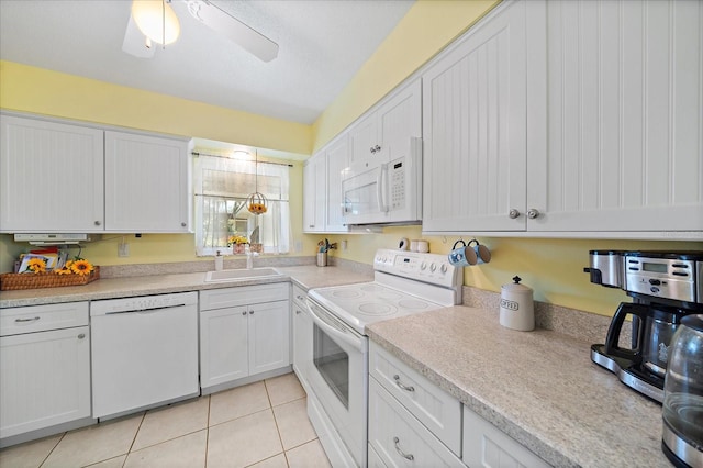 kitchen featuring white appliances, ceiling fan, light tile floors, sink, and white cabinetry