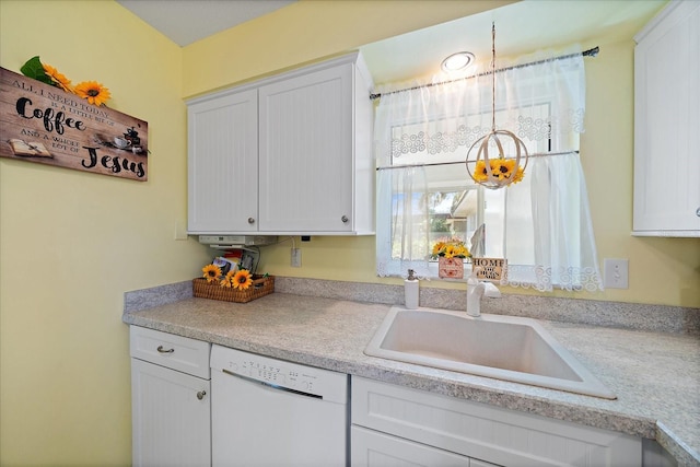 kitchen with white cabinetry, sink, and white dishwasher