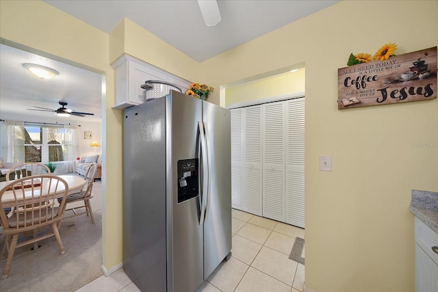 kitchen featuring stainless steel fridge with ice dispenser, ceiling fan, white cabinets, and light carpet