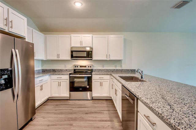 kitchen featuring light stone countertops, sink, light wood-type flooring, stainless steel appliances, and white cabinets